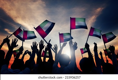 Group Of People Waving Flag Of UAE In Back Lit