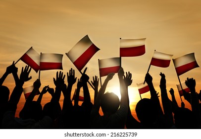 Group of People Waving Polish Flags in Back Lit - Shutterstock ID 216225739
