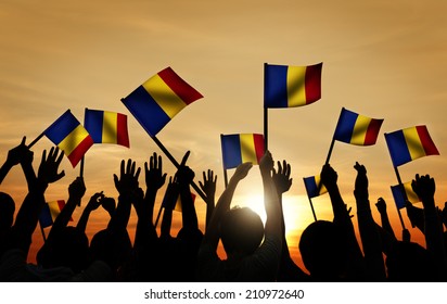 Group Of People Waving Romanian Flags In Back Lit