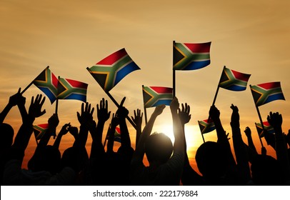 Group Of People Waving South African Flags In Back Lit