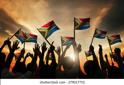 Group of People Waving South African Flags in Back Lit Concept