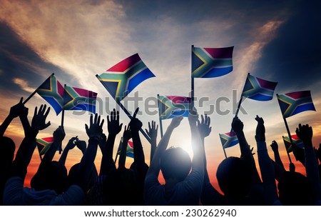 Group of People Waving South African Flags in Back Lit