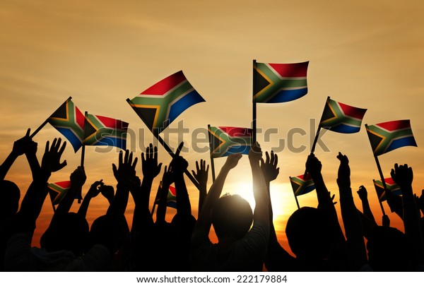 Group of\
People Waving South African Flags in Back\
Lit