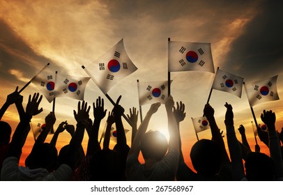 Group Of People Waving South Korea Flags In Back Lit