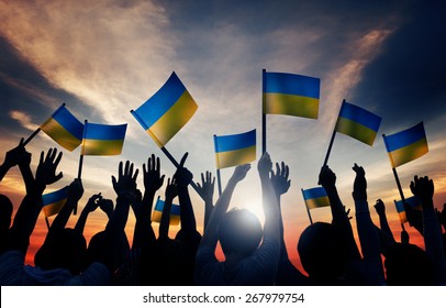 Group of People Waving Ukranian Flags in Back Lit - Powered by Shutterstock