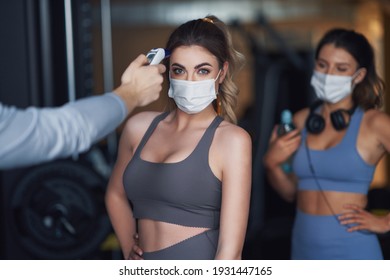 Group of people wearing masks entering a gym - Powered by Shutterstock