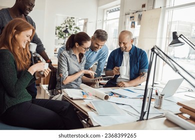 Group of people working together on a project in a startup company office - Shutterstock ID 2368399265