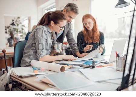 Group of people working together on a project in a startup company office