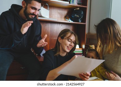Group of people young woman caucasian female student sitting at home with her friends and family holding envelope with mail letter happy exited smiling reading entry test results success concept