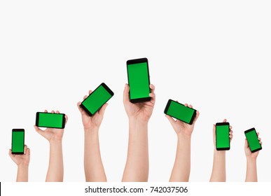 Group Of People's Hands Holding Phones And Rising Them Up 