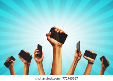 Group Of People's Hands Holding Phones And Rising Them Up