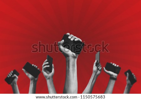 group of people's hands holding phones and rising them up against a red background