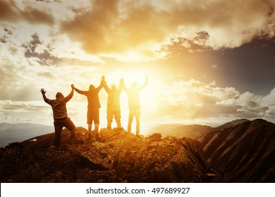 Group Of Peoples On Mountains Top In Winner Pose