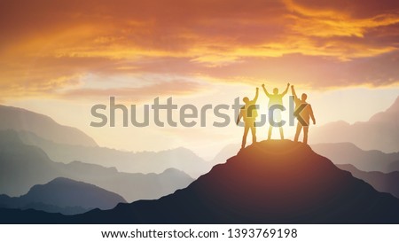 Group of peoples on mountains top in winner pose. Leadership Concept