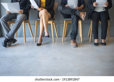 Group Of Peoples Are Sitting To Review The Documents While Waiting For A Job Interview.