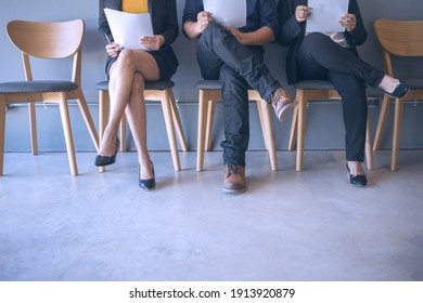 Group Of Peoples Are Sitting To Review The Documents While Waiting For A Job Interview.