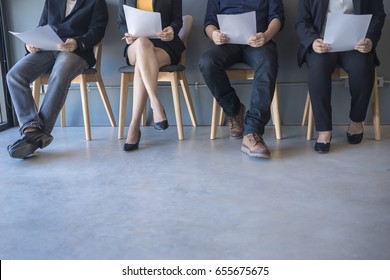 Group of peoples are sitting to review the documents while waiting for a job interview. - Shutterstock ID 655675675
