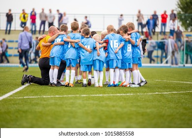 Group Pep Talk. Coaching Youth Soccer Team Before The Game