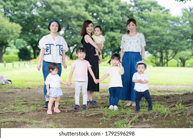 Group Photo Of Asian Families Playing In A Green Park