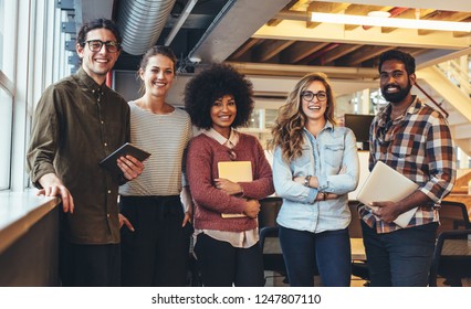 Group Photo Of Five People From A Small Startup Companies. Entrepreneurs Doing Business.