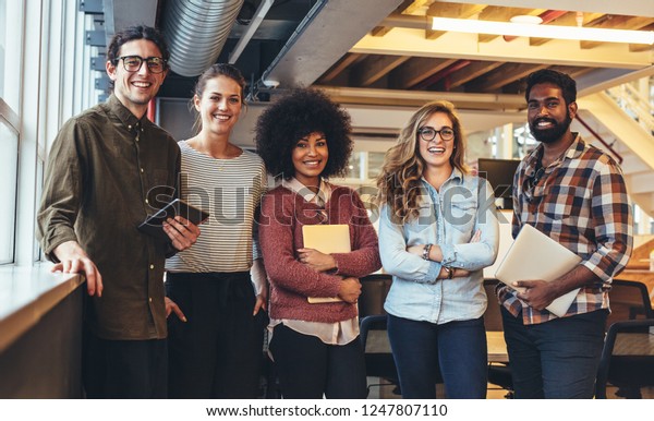 Group photo of five people from a small\
startup companies. Entrepreneurs doing\
business.
