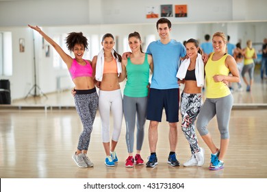 Group Photo Of Smiling Sporty People On Fitness Class After Training