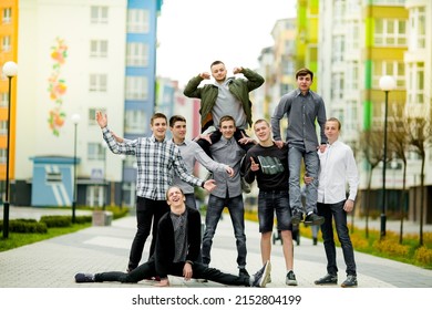 Group Photo Of Teenage Students Having Fun In Their Free Time. Teasing And Funny Photos Of High School Or College Students. All Brands Are Hidden.