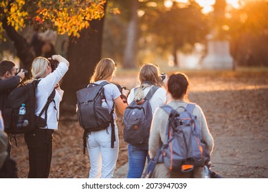 Group of photographer taking pictures of family on photography shooting workshop, outdoor - Shutterstock ID 2073947039