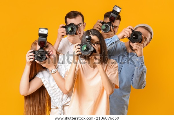 Group of\
photographers on color\
background