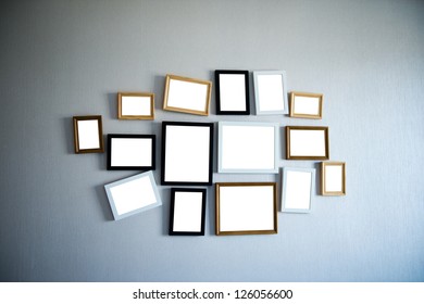 Group Of Picture Frames On The Wall.