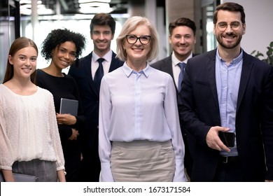 Group Picture Of Smiling Multiracial Employees Team Pose Together Looking At Camera In Office, Happy Diverse Multiethnic Colleagues Show Unity And Motivation At Work, Career, Employment Concept