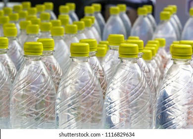 Group Of Plastic Bottles With Water Stand In A Row. Close-up