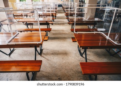 Group of plastic partition (or table shield) setting on table in canteen for reduce and protection the COVID-19 virus spreads in pandemic. Social distancing concept.