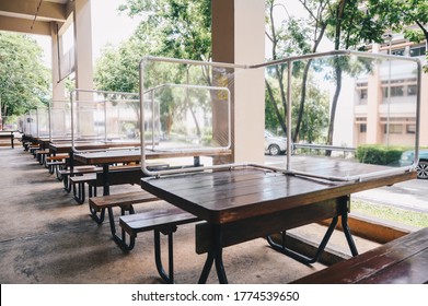 Group of plastic partition setting on table in canteen for reduce and protection the COVID-19 virus spreads in pandemic. Social distancing concept.