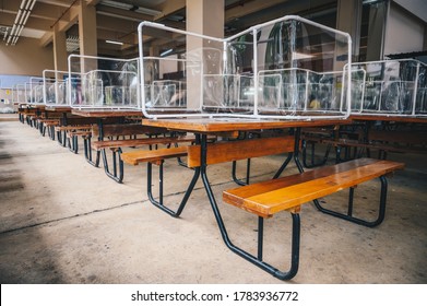 Group of plastic partition setting on table in canteen for reduce and protection the COVID-19 virus spreads in pandemic. Social distancing concept.