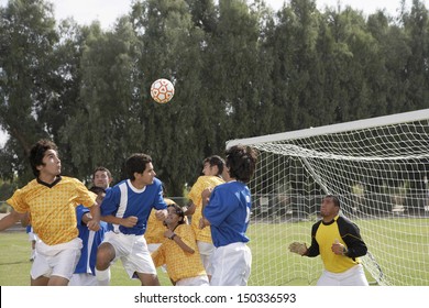 Group Of Players Playing Soccer On Field