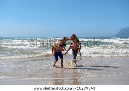 Group playing in surf