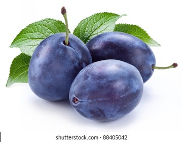 Group of plums with plum leaves isolated on a white background.