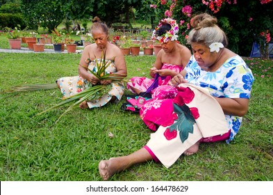 Group of Polynesian Pacific Island Tahitian senior females sewing Tivaivai and weaving a hat knees out of palm leaves in home garden in Aitutaki Island in the Cook Islands.Real people. Copy space - Powered by Shutterstock