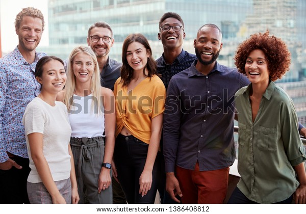 Group portrait of a creative
business team standing outdoors, three quarter length, close
up