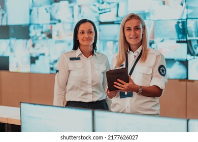 Group Portrait Of Female Security Operator While Working In A Data System Control Room Offices Technical Operator Working At Workstation With Multiple Displays, Security Guard Working On Multiple Mon