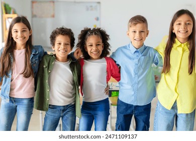 Group portrait of happy diverse school friends. embracing and posing in classroom, looking at the camera and smiling - Powered by Shutterstock