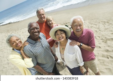 Group portrait of happy multiethnic couples smiling on the beach - Powered by Shutterstock