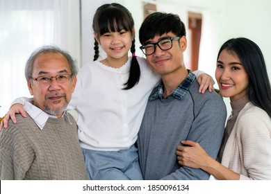 Group Portrait Of Happy Multigenerational Asian Family Standing In Living Room With Smile In New Apartment. Muti Genration Family Happiness Concept.