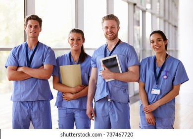 Group portrait of healthcare workers in hospital corridor