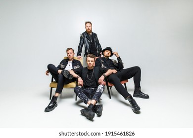 Group Portrait Of Men In Black Clothes On A White Background