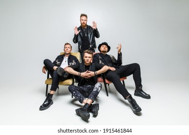 Group Portrait Of Men In Black Clothes On A White Background