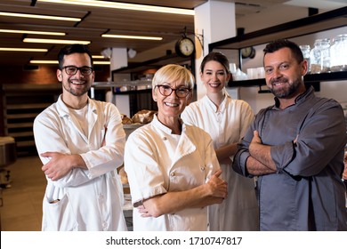 Group Portrait Of Multi Generation Team Of Bakers At Bakery.