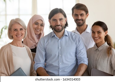 Group Portrait Of Multicultural Colleagues Stand Look At Camera Posing For Picture In Office Together, Smiling International Multiethnic Employees Make Photo Show Unity And Support At Work