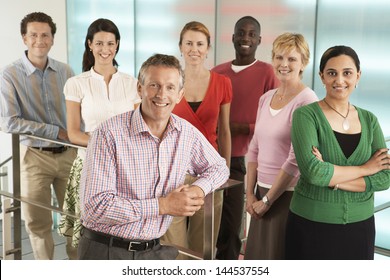Group portrait of multiethnic business people smiling in office